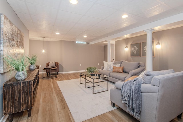 9117 Cambridge Dr, Saline, MI 48176 - living room with wood finished floors, decorative columns, and baseboards