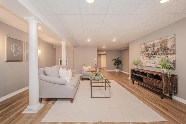 9117 Cambridge Dr, Saline, MI 48176 - living area featuring ornate columns, wood finished floors, baseboards, and recessed lighting