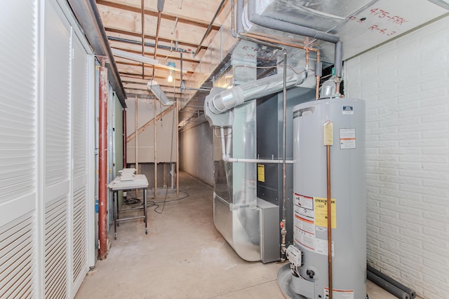 9117 Cambridge Dr, Saline, MI 48176 - unfinished below grade area featuring gas water heater, brick wall, and heating unit