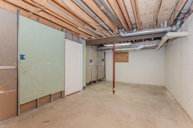 9117 Cambridge Dr, Saline, MI 48176 - unfinished basement with brick wall