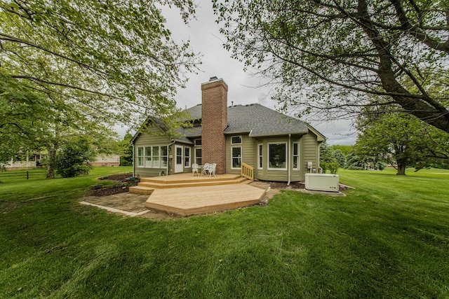 9117 Cambridge Dr, Saline, MI 48176 - back of house with a deck, a yard, a chimney, and a shingled roof