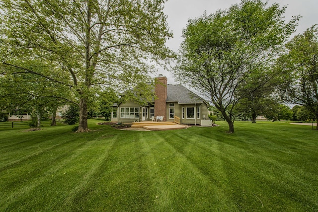 9117 Cambridge Dr, Saline, MI 48176 - rear view of house featuring a chimney and a patio area