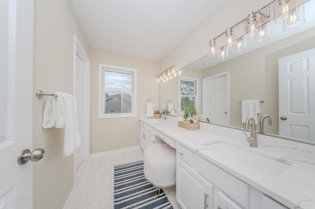 9117 Cambridge Dr, Saline, MI 48176 - bathroom with double vanity, baseboards, and tile patterned flooring