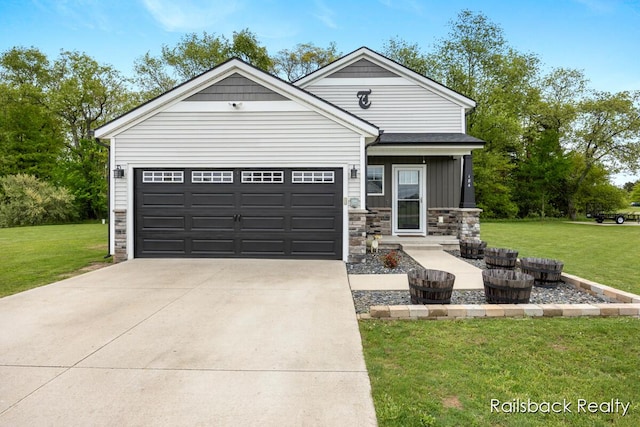 184 Dana Ln, Sand Lake, MI 49343 - view of front of home featuring stone siding, a front yard, driveway, and an attached garage