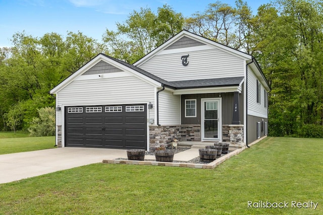 184 Dana Ln, Sand Lake, MI 49343 - view of front of home featuring a garage, driveway, stone siding, and a front lawn