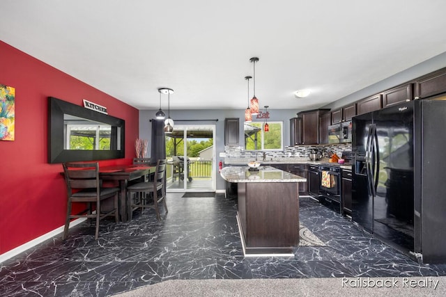 184 Dana Ln, Sand Lake, MI 49343 - kitchen featuring black appliances, a kitchen island, dark brown cabinets, backsplash, and decorative light fixtures