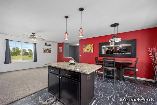184 Dana Ln, Sand Lake, MI 49343 - kitchen featuring a ceiling fan, dark marble finish floors, decorative light fixtures, a center island, and open floor plan