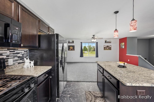 184 Dana Ln, Sand Lake, MI 49343 - kitchen with black appliances, ceiling fan, dark marble finish floors, dark brown cabinets, and wooden walls