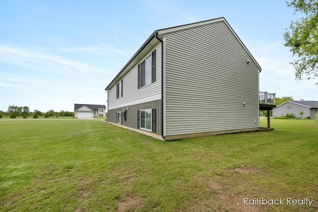 184 Dana Ln, Sand Lake, MI 49343 - view of side of property with a yard, a detached garage, and a deck