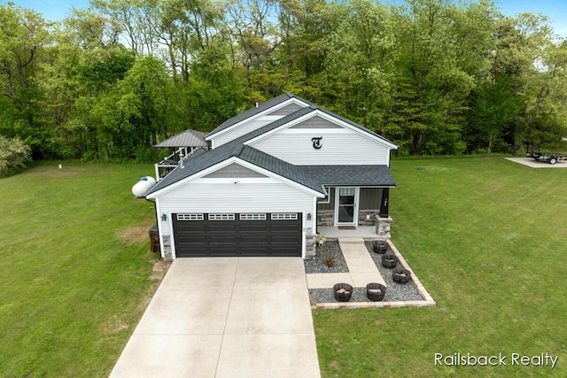 184 Dana Ln, Sand Lake, MI 49343 - view of front of house with roof with shingles, a front yard, concrete driveway, and stone siding