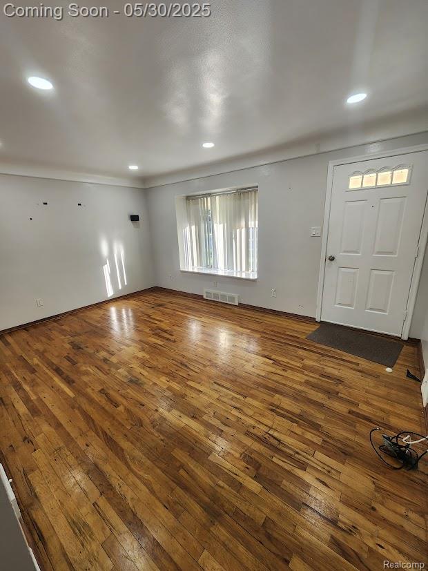 2625 Winston Dr, Sterling Heights, MI 48310 - unfurnished living room featuring hardwood / wood-style floors, recessed lighting, and ornamental molding