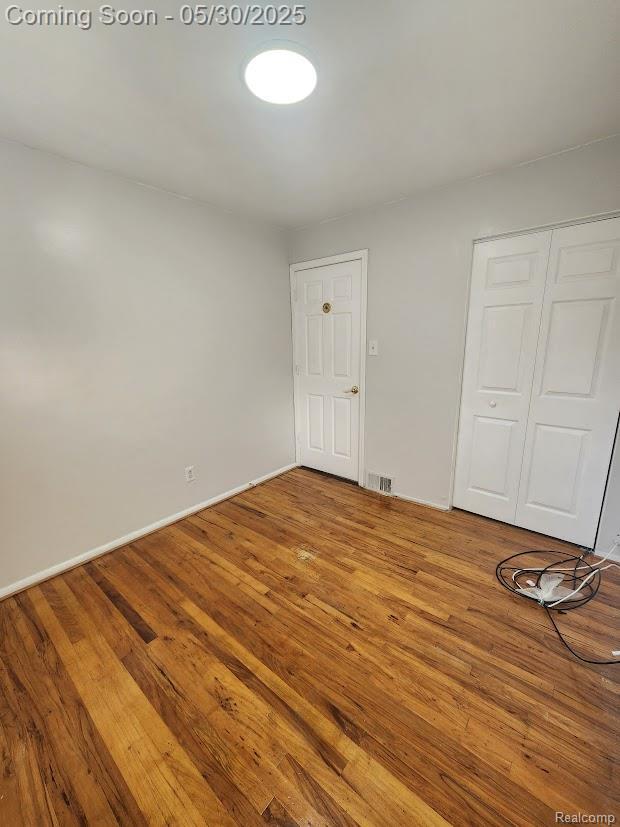 2625 Winston Dr, Sterling Heights, MI 48310 - unfurnished bedroom featuring a closet, wood finished floors, and baseboards