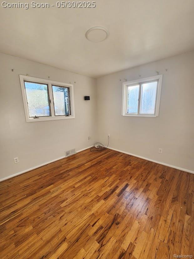 2625 Winston Dr, Sterling Heights, MI 48310 - spare room with wood finished floors and baseboards