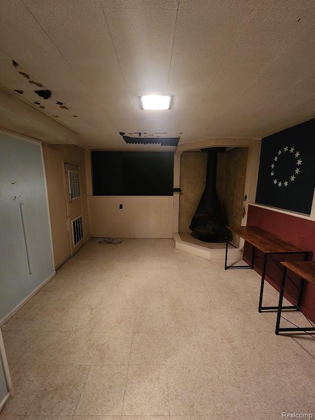 2625 Winston Dr, Sterling Heights, MI 48310 - basement with a wood stove