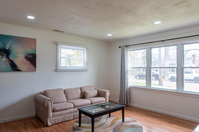 23067 Stauber Ave, Hazel Park, MI 48030 - living room featuring a textured ceiling, light wood-style flooring, recessed lighting, and baseboards
