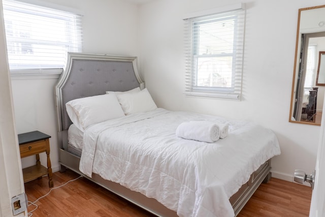23067 Stauber Ave, Hazel Park, MI 48030 - bedroom featuring wood finished floors, multiple windows, and baseboards