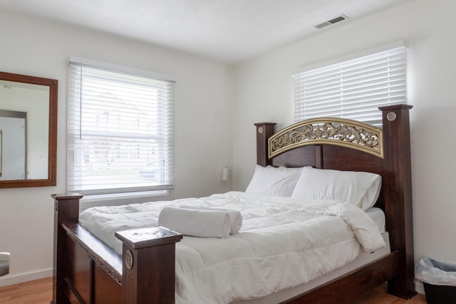 23067 Stauber Ave, Hazel Park, MI 48030 - bedroom with wood finished floors, multiple windows, and baseboards