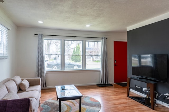 23067 Stauber Ave, Hazel Park, MI 48030 - living area with light wood-type flooring, healthy amount of natural light, a textured ceiling, recessed lighting, and baseboards