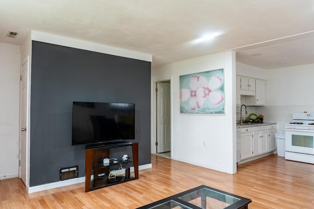 23067 Stauber Ave, Hazel Park, MI 48030 - living room featuring light wood-style flooring and baseboards