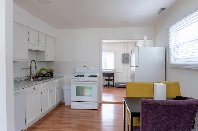 23067 Stauber Ave, Hazel Park, MI 48030 - kitchen with white appliances, a sink, light wood finished floors, white cabinets, and decorative backsplash