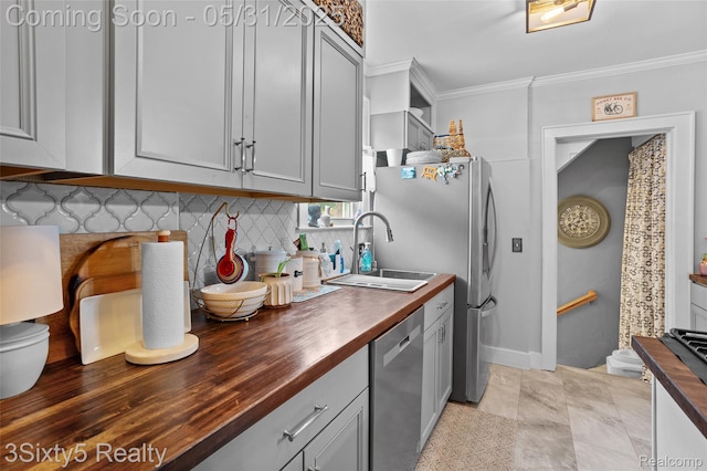 6568 Balfour Ave, Allen Park, MI 48101 - kitchen featuring butcher block counters, stainless steel appliances, ornamental molding, decorative backsplash, and a sink