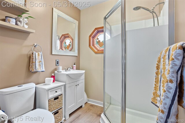 6568 Balfour Ave, Allen Park, MI 48101 - bathroom featuring a stall shower, vanity, wood finished floors, and toilet