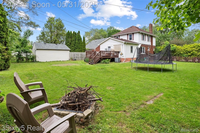 6568 Balfour Ave, Allen Park, MI 48101 - view of yard featuring a trampoline, a deck, a fire pit, and central AC