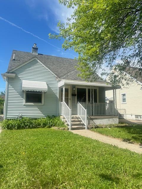 1858 Leblanc St, Lincoln Park, MI 48146 - view of front of house featuring covered porch, a front yard, a chimney, and roof with shingles