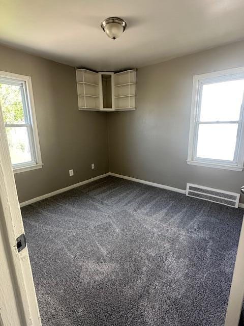 1858 Leblanc St, Lincoln Park, MI 48146 - empty room featuring dark colored carpet and baseboards