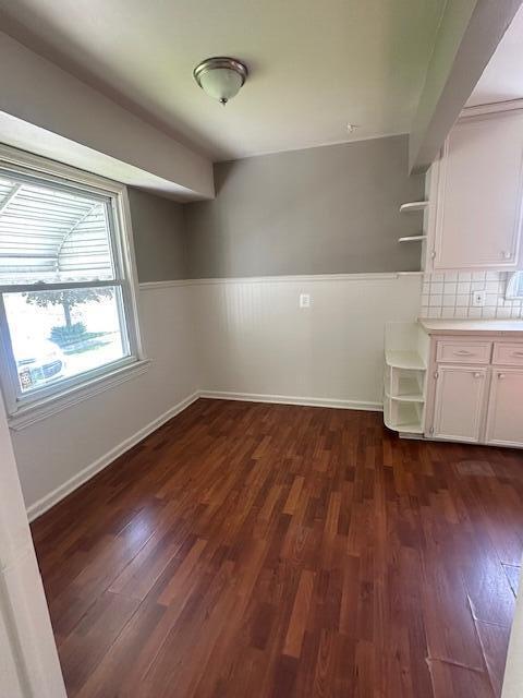 1858 Leblanc St, Lincoln Park, MI 48146 - unfurnished dining area featuring dark wood-style floors, wainscoting, and baseboards