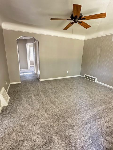 1858 Leblanc St, Lincoln Park, MI 48146 - carpeted empty room featuring arched walkways, a ceiling fan, and baseboards