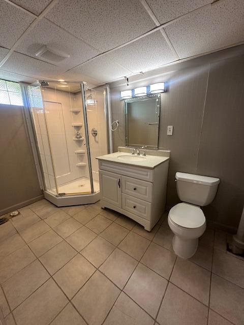 1858 Leblanc St, Lincoln Park, MI 48146 - full bath featuring a shower stall, vanity, toilet, tile patterned flooring, and a paneled ceiling