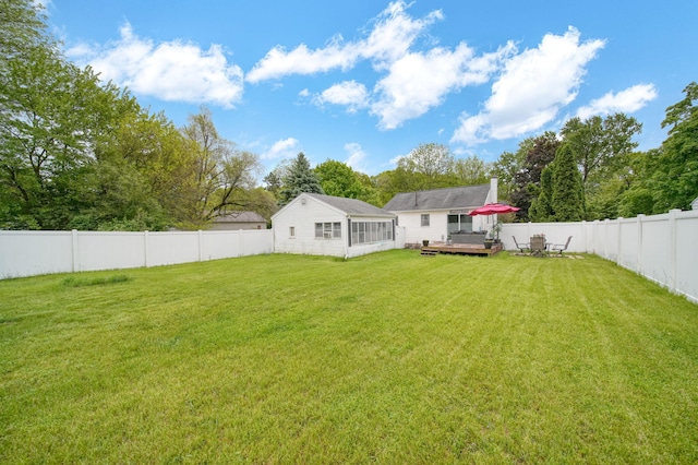 912 Gerald Ave, Jackson, MI 49203 - back of property featuring a deck, a chimney, and a sunroom