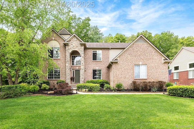 29811 Bradford Dr, New Hudson, MI 48165 - traditional-style house featuring a front yard, brick siding, and a shingled roof