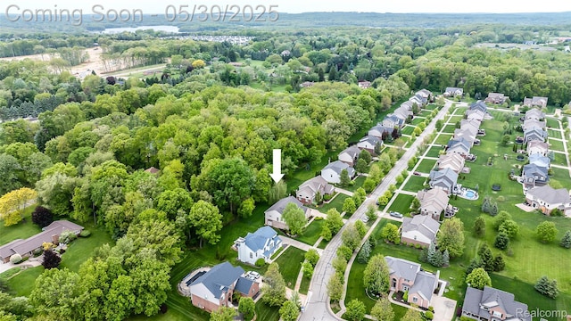 29811 Bradford Dr, New Hudson, MI 48165 - aerial perspective of suburban area featuring a forest