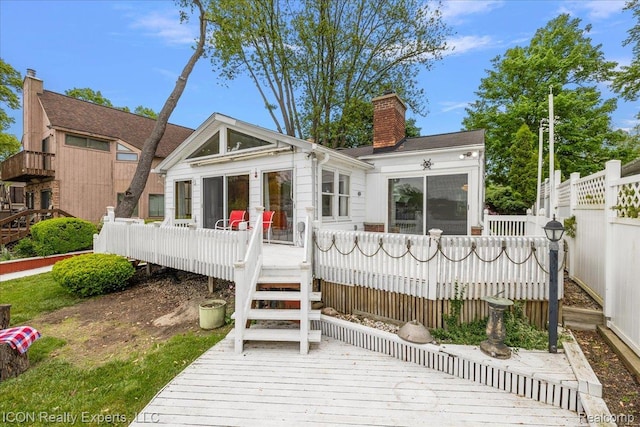 8569 Cooley Beach Dr, White Lake, MI 48386 - back of property featuring a wooden deck, a chimney, stairs, and a sunroom
