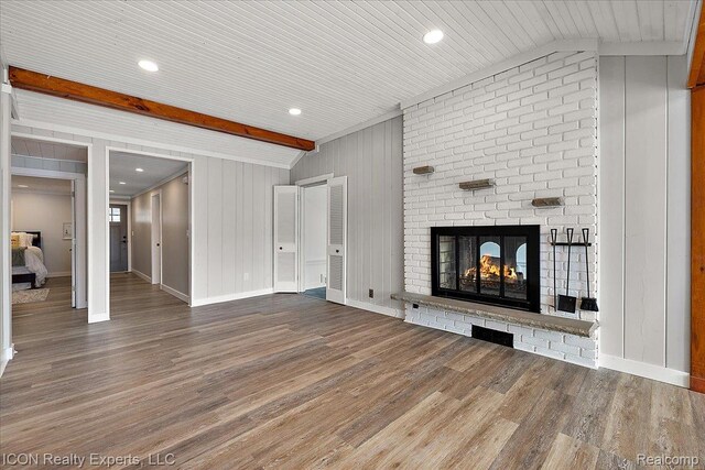 8569 Cooley Beach Dr, White Lake, MI 48386 - unfurnished living room featuring wood finished floors, a brick fireplace, baseboards, and recessed lighting