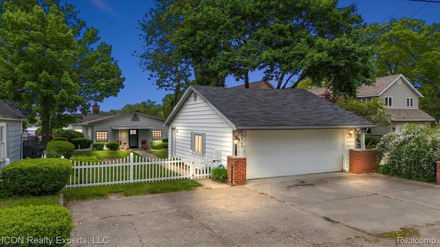 8569 Cooley Beach Dr, White Lake, MI 48386 - view of front of home with a fenced front yard and driveway