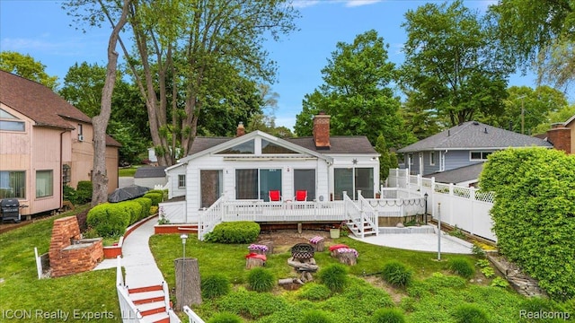 8569 Cooley Beach Dr, White Lake, MI 48386 - back of property with a chimney and a deck