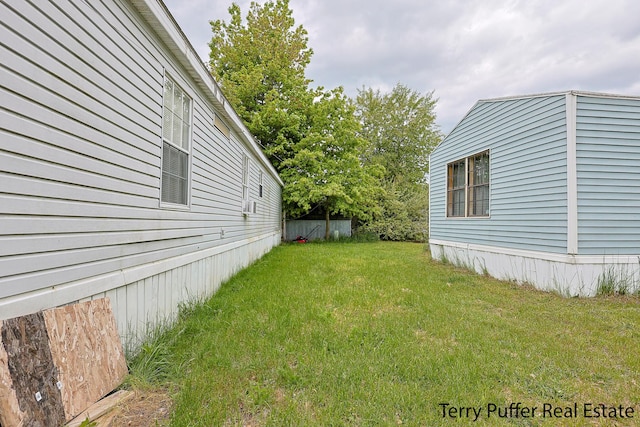 1281 E Pontaluna Rd Lot 113, Norton Shores, MI 49456 - view of grassy yard