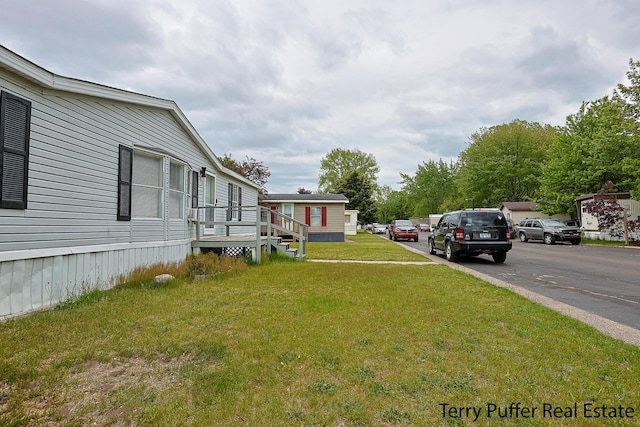 1281 E Pontaluna Rd Lot 113, Norton Shores, MI 49456 - view of grassy yard