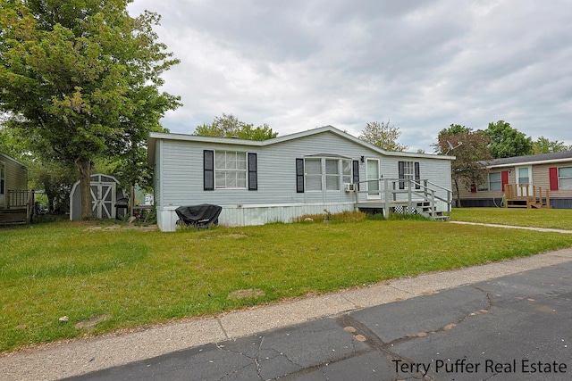 1281 E Pontaluna Rd Lot 113, Norton Shores, MI 49456 - manufactured / mobile home with a deck and a front lawn
