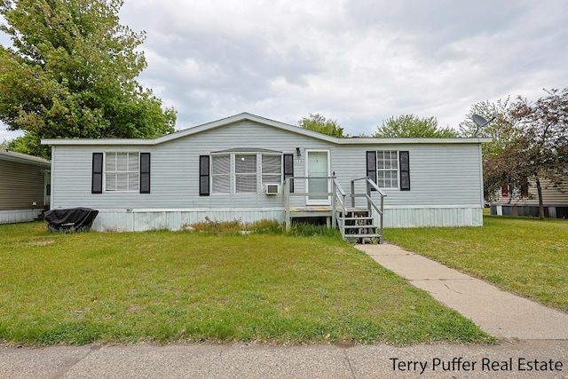 1281 E Pontaluna Rd Lot 113, Norton Shores, MI 49456 - manufactured / mobile home featuring a front lawn and cooling unit