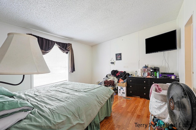 1281 E Pontaluna Rd Lot 113, Norton Shores, MI 49456 - bedroom featuring light wood-style floors and a textured ceiling