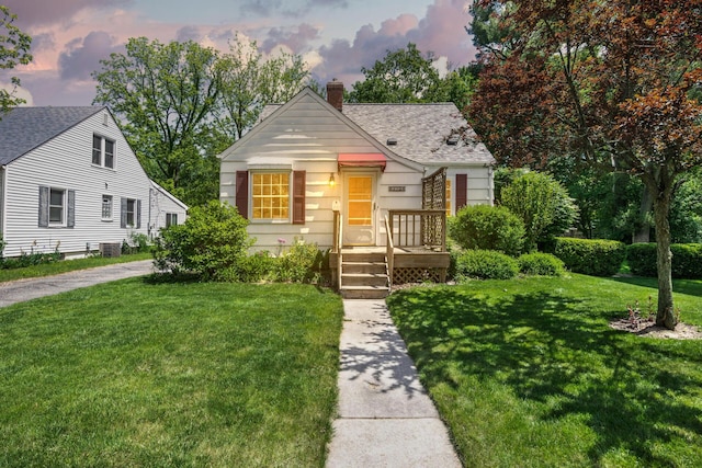 172 N Mansfield St, Ypsilanti, MI 48197 - bungalow featuring a chimney, a lawn, and a shingled roof