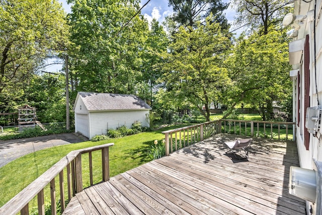 172 N Mansfield St, Ypsilanti, MI 48197 - deck with an outbuilding, a lawn, view of scattered trees, and a garage
