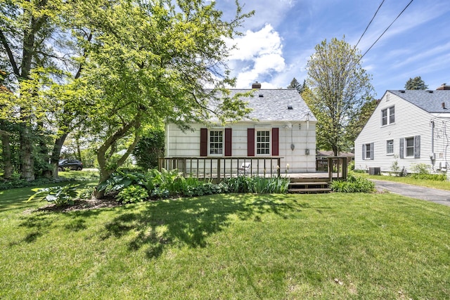 172 N Mansfield St, Ypsilanti, MI 48197 - view of front of property with a deck, a front lawn, a chimney, and cooling unit