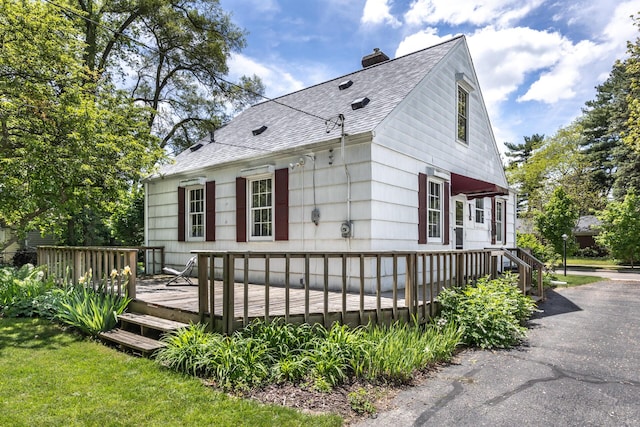172 N Mansfield St, Ypsilanti, MI 48197 - view of property exterior with roof with shingles, a chimney, and a wooden deck