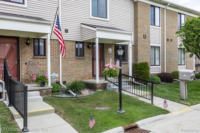 1660 River Rd Unit 52, Marysville, MI 48040 - property entrance with a yard, brick siding, and a porch