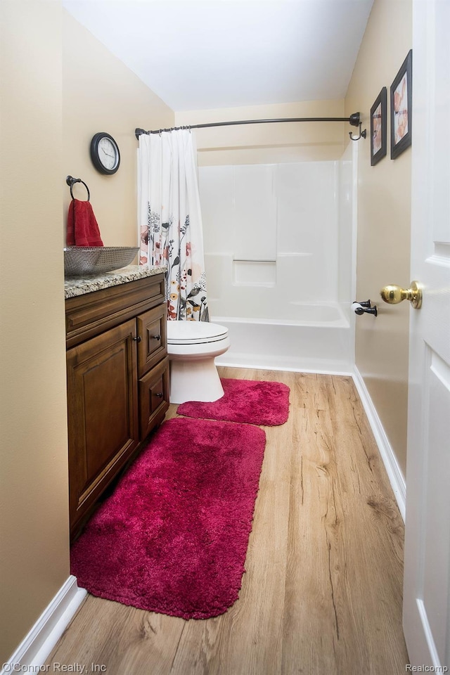 1660 River Rd Unit 52, Marysville, MI 48040 - bathroom featuring toilet, wood finished floors, shower / bath combo with shower curtain, and vanity